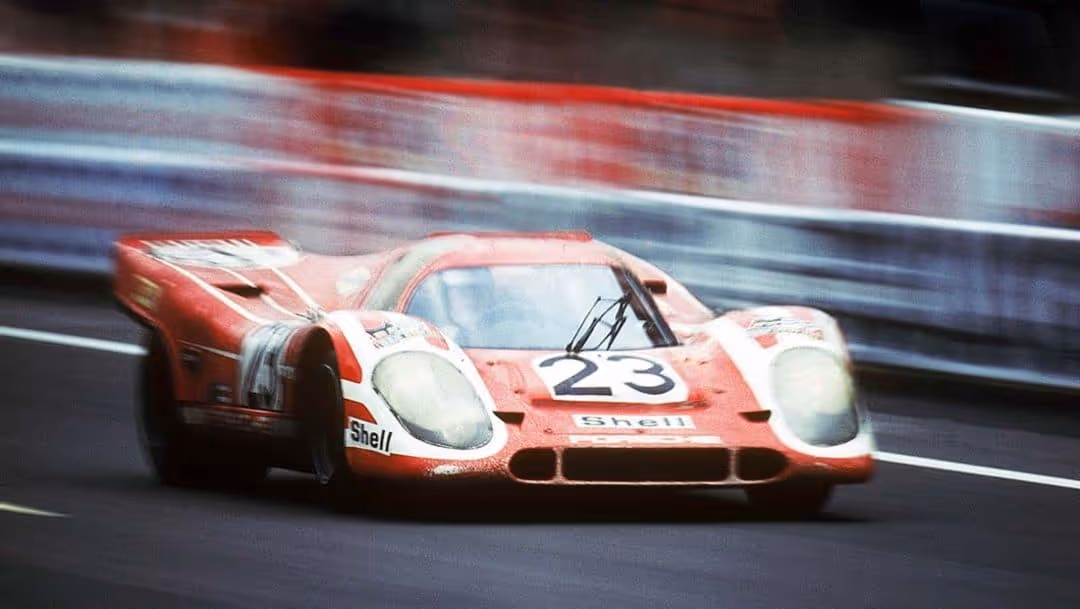Red Porsche racing car at Le Mans.