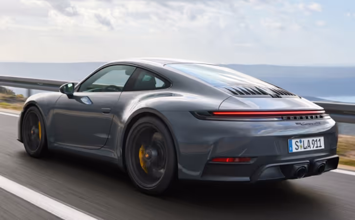 Gray Porsche 911 Carrera driving.