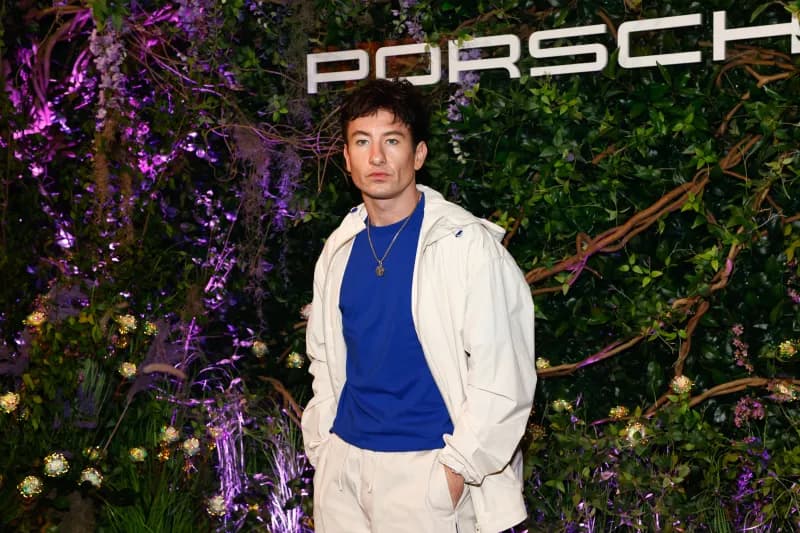 Barry Keoghan at the 2024 Met Gala in front of a Porsche wall.